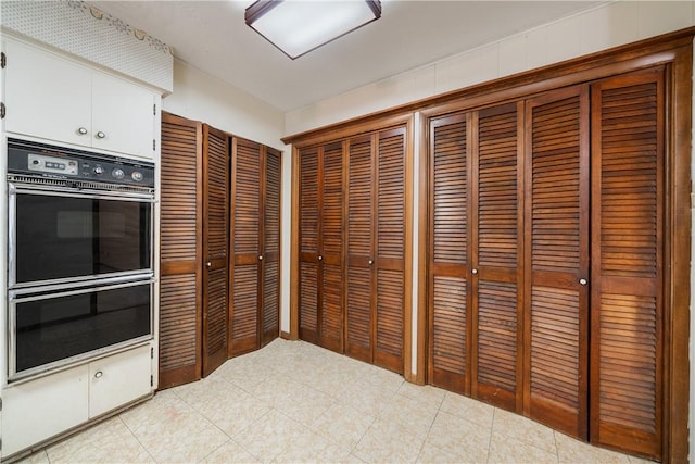 kitchen featuring white cabinetry and double oven