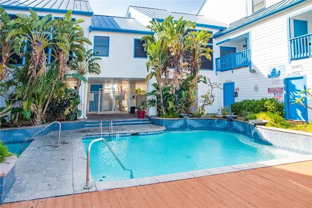 view of swimming pool with pool water feature