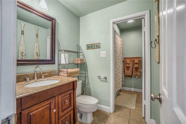 bathroom featuring vanity, toilet, a textured ceiling, and tile patterned flooring