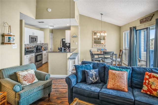 living room featuring hardwood / wood-style flooring, a textured ceiling, lofted ceiling, and a notable chandelier