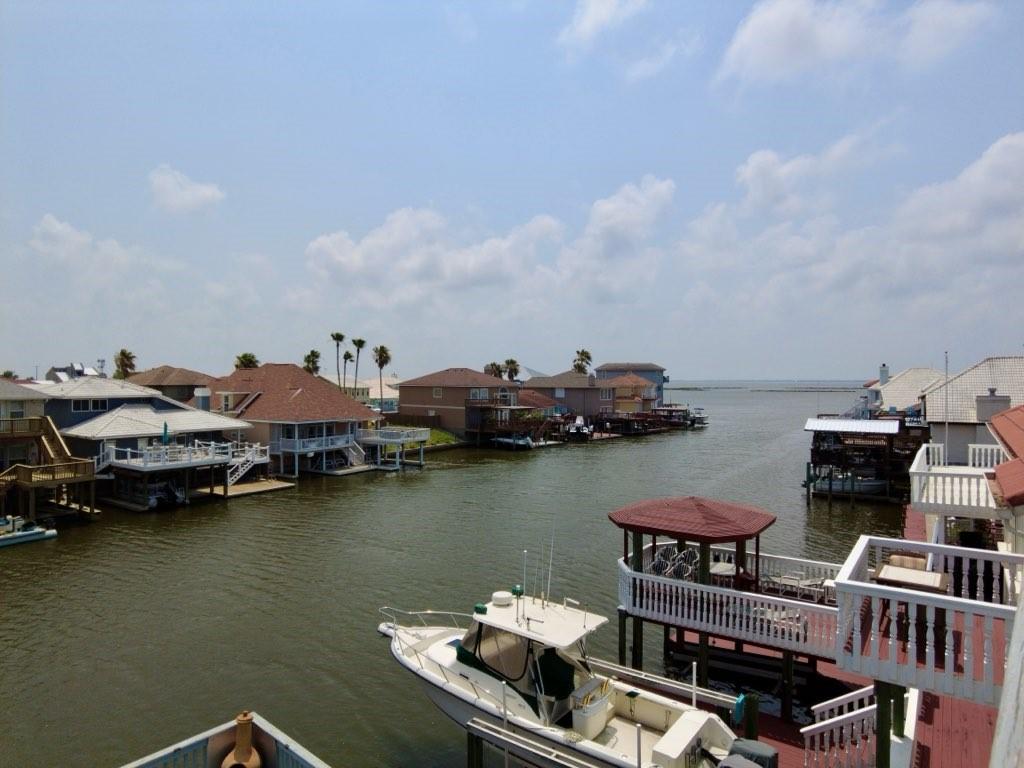 dock area with boat lift and a water view