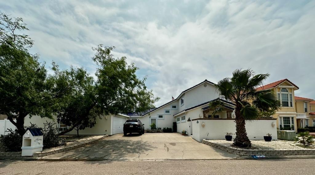view of front of property with concrete driveway, a garage, and stucco siding