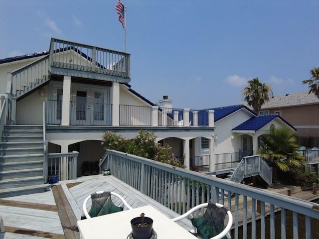wooden terrace featuring stairs and a fire pit