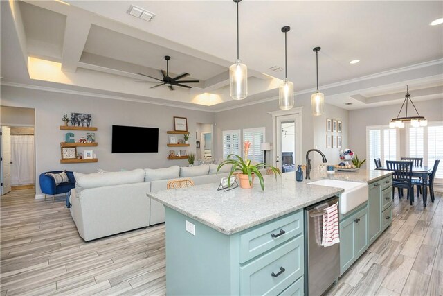 6401 Kobe Dr, Corpus Christi, TX 78414 - kitchen with stainless steel dishwasher, a kitchen island with sink, light wood-type flooring, a ceiling fan, and crown molding