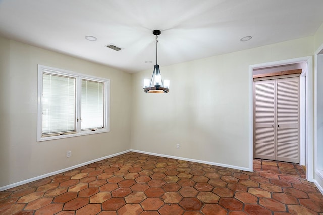 unfurnished dining area featuring a chandelier