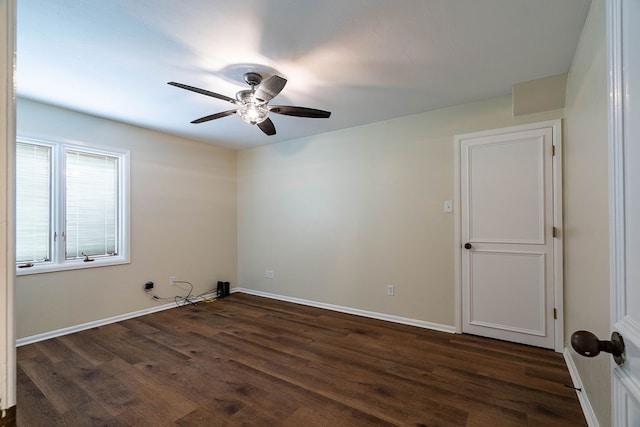 spare room with dark hardwood / wood-style floors and ceiling fan