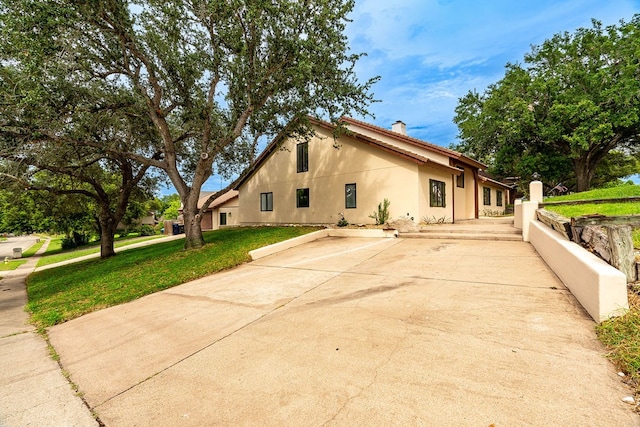 view of property exterior with a lawn