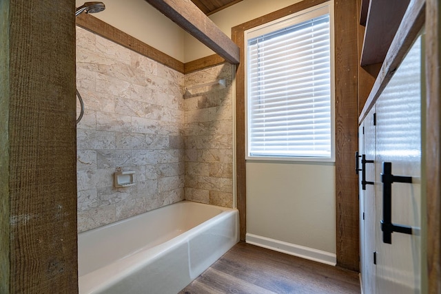 bathroom featuring hardwood / wood-style floors and tiled shower / bath combo