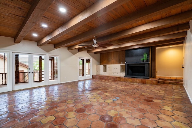 unfurnished living room with beam ceiling, ceiling fan, french doors, and wooden ceiling