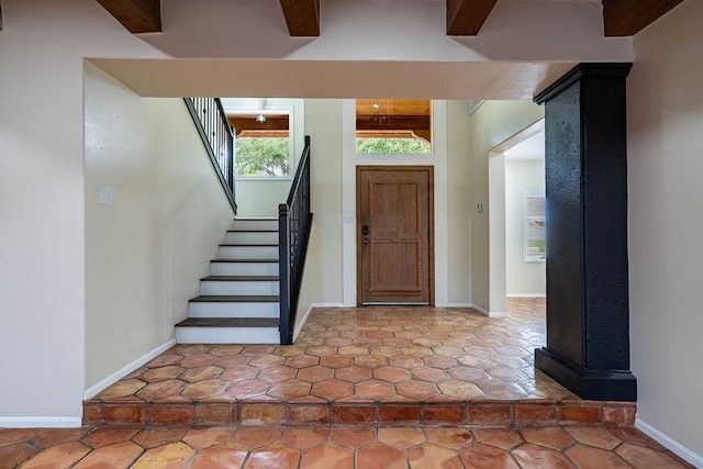 entryway featuring beamed ceiling