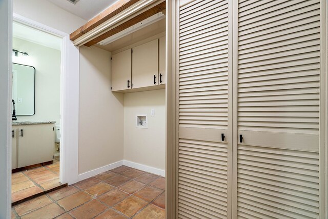 laundry room with hookup for a washing machine and cabinets