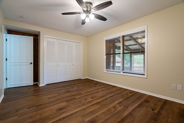 unfurnished bedroom with ceiling fan, dark hardwood / wood-style flooring, and a closet