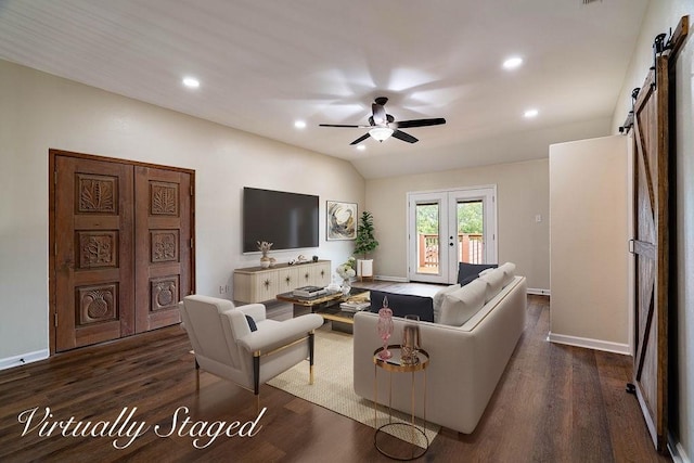 living room featuring dark wood-type flooring, french doors, vaulted ceiling, ceiling fan, and a barn door