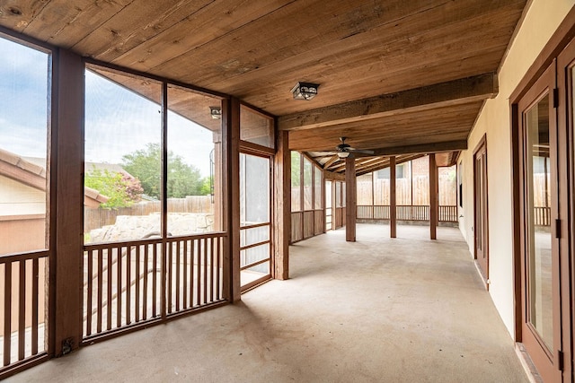 unfurnished sunroom featuring ceiling fan and wooden ceiling