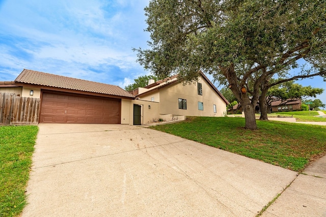 view of front of house with a garage and a front lawn