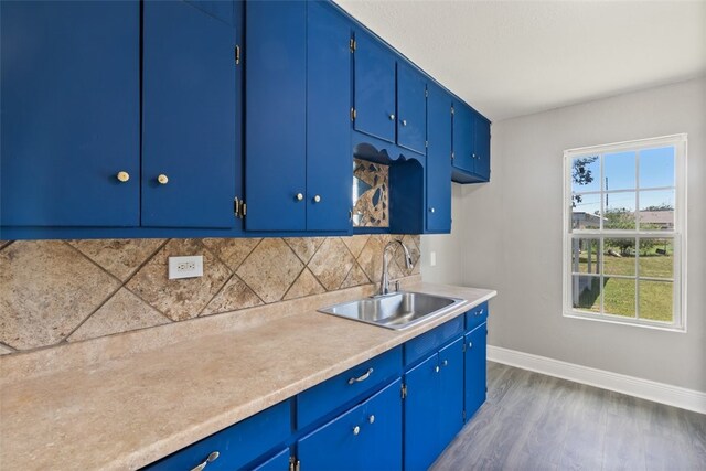 4513 Green Grove Dr, Corpus Christi, TX 78415 - kitchen featuring backsplash, light countertops, dark wood finished floors, and blue cabinetry