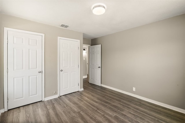 4513 Green Grove Dr, Corpus Christi, TX 78415 - unfurnished bedroom with baseboards and dark wood-type flooring