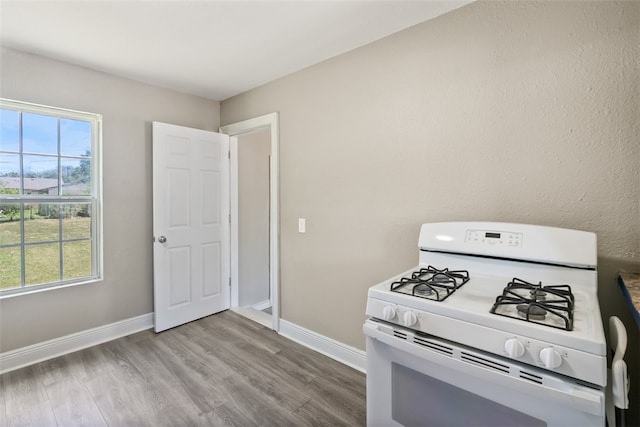 4513 Green Grove Dr, Corpus Christi, TX 78415 - kitchen featuring white range with gas stovetop and wood finished floors