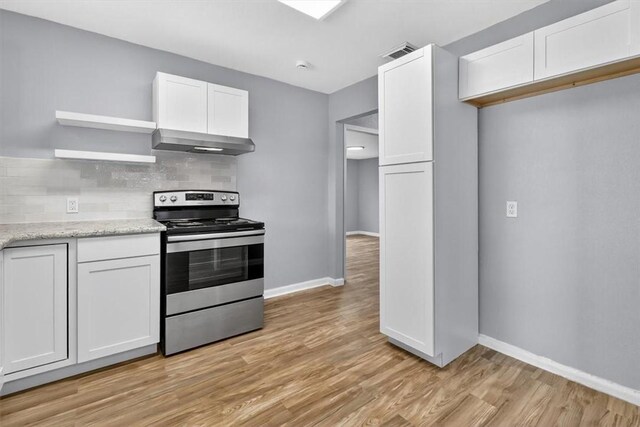 741 Lansdown Dr, Corpus Christi, TX 78412 - kitchen featuring stainless steel electric stove, exhaust hood, light wood finished floors, and white cabinets