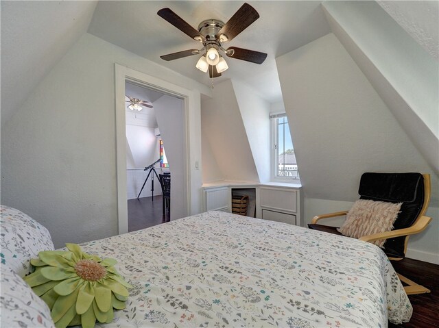 bedroom with ceiling fan, dark hardwood / wood-style floors, and lofted ceiling