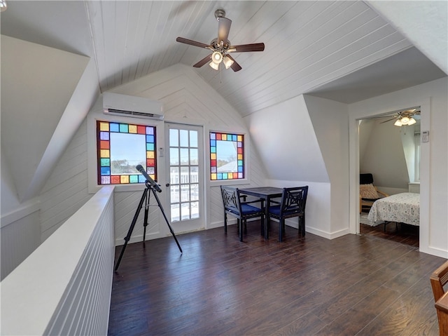 interior space with dark hardwood / wood-style flooring, lofted ceiling, an AC wall unit, and ceiling fan