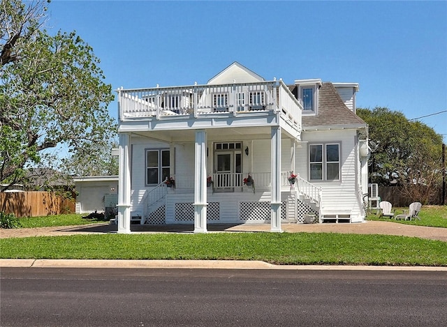 view of front of home featuring covered porch and a front yard