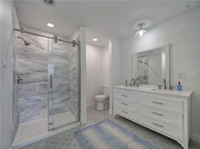 bathroom featuring vanity, walk in shower, tile patterned floors, and toilet