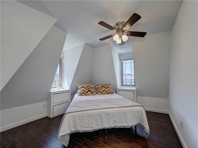 bedroom with dark wood-type flooring, multiple windows, vaulted ceiling, and ceiling fan