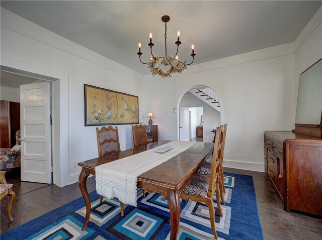 dining space featuring dark hardwood / wood-style flooring and a chandelier