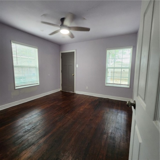 spare room with ceiling fan and dark hardwood / wood-style floors