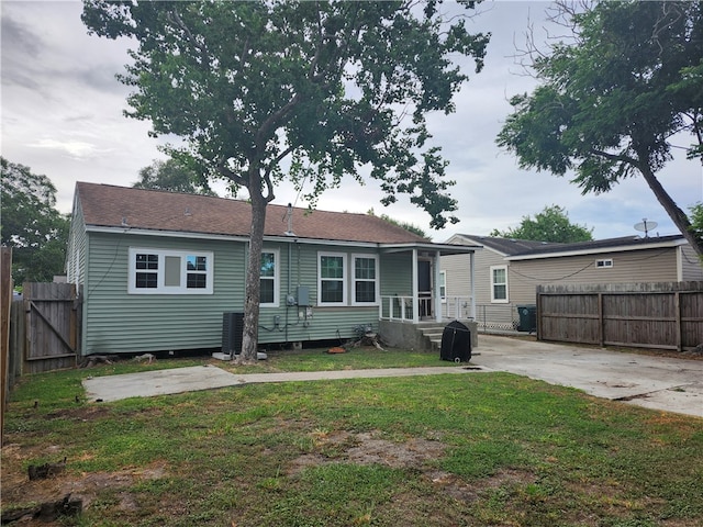 back of house with a lawn