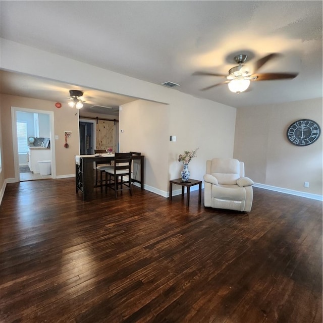 living area featuring dark hardwood / wood-style floors and ceiling fan