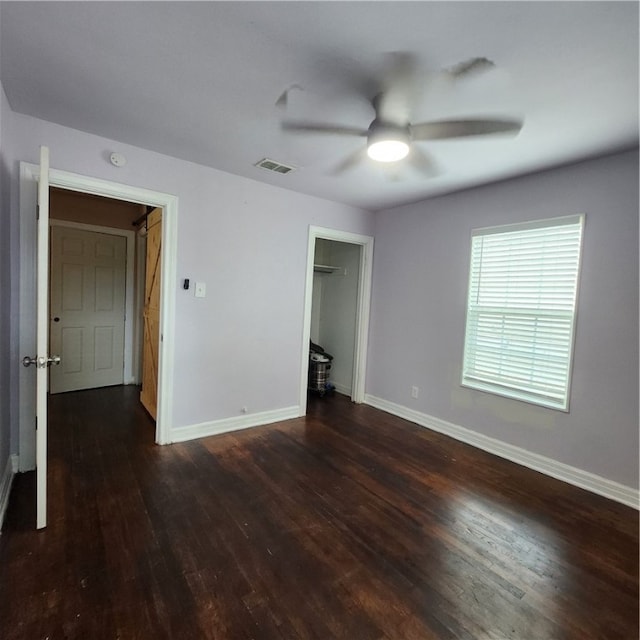 unfurnished bedroom featuring ceiling fan, dark hardwood / wood-style floors, and a closet