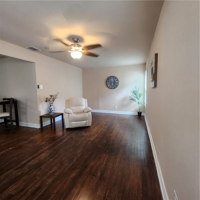 sitting room with ceiling fan and dark hardwood / wood-style floors