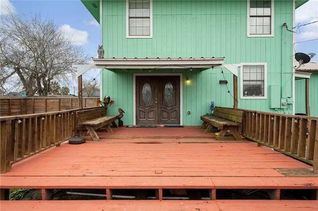 back of property featuring a wooden deck and fence