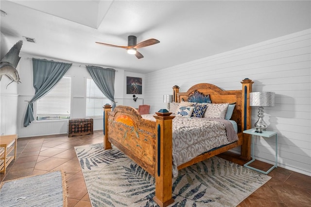 bedroom featuring ceiling fan, visible vents, and tile patterned floors