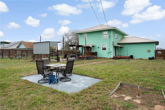 view of yard featuring a deck, a patio area, and fence