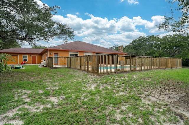 view of yard with a fenced in pool and a patio area