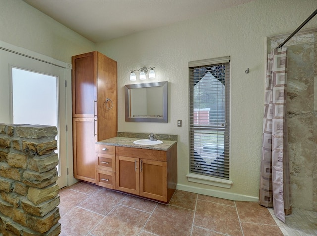 bathroom with walk in shower and vanity