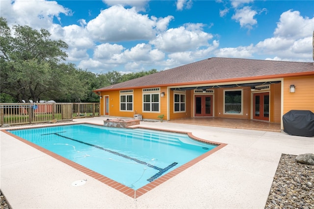 view of pool with ceiling fan, a grill, french doors, and a patio area