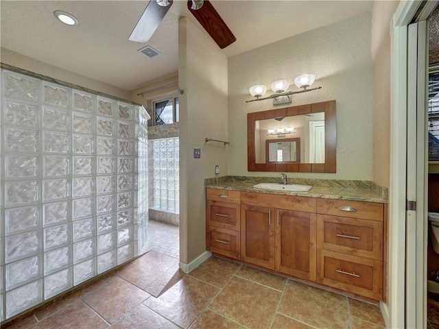 bathroom featuring toilet, vanity, and ceiling fan