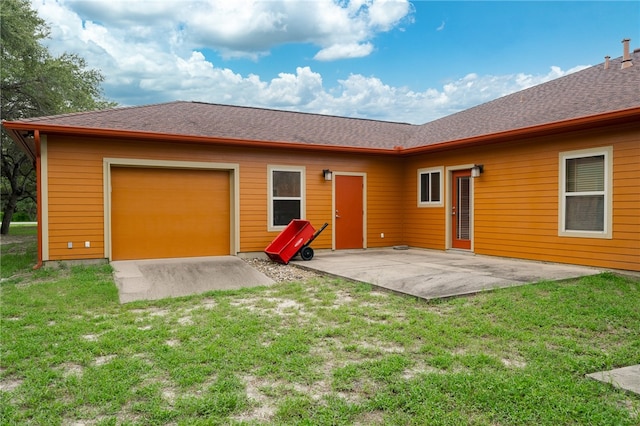 rear view of house with a yard and a patio area