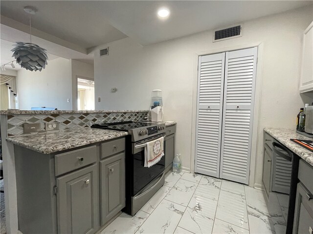 kitchen with gray cabinets, tasteful backsplash, stainless steel stove, and stone countertops