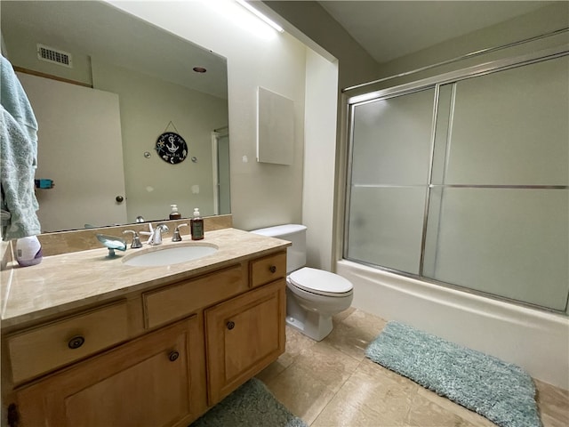 full bathroom featuring toilet, combined bath / shower with glass door, vanity, and tile patterned floors