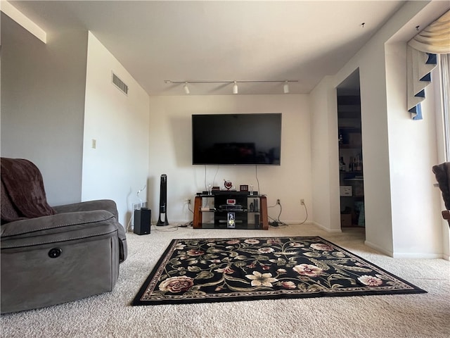 living room with rail lighting and carpet