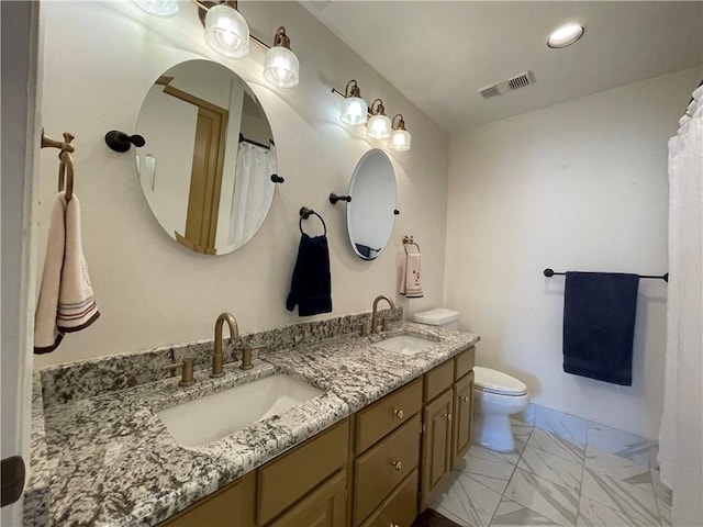 520 S Chaparral St Unit 402, Corpus Christi, TX 78401 - bathroom with marble look tiles, double vanity, toilet, and recessed lighting