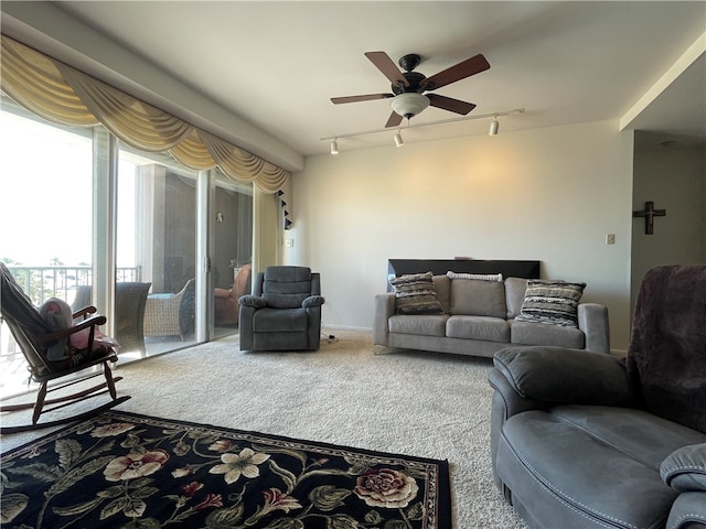 carpeted living room featuring rail lighting and ceiling fan