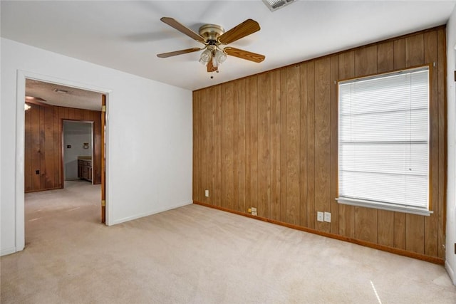 5802 Riley Dr, Corpus Christi, TX 78412 - unfurnished room featuring wood walls, a ceiling fan, and light colored carpet
