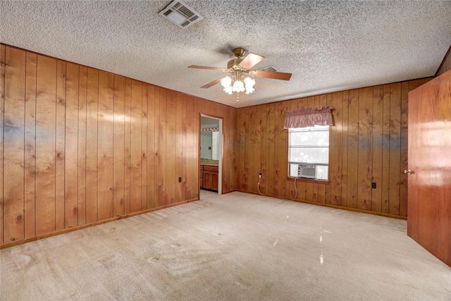 5802 Riley Dr, Corpus Christi, TX 78412 - empty room featuring carpet flooring, a ceiling fan, wooden walls, cooling unit, and a textured ceiling