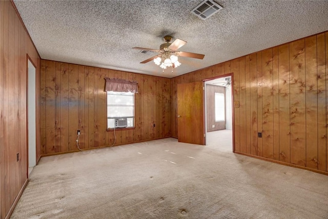 5802 Riley Dr, Corpus Christi, TX 78412 - carpeted empty room with ceiling fan, wooden walls, and a textured ceiling